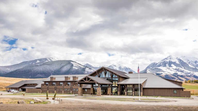 Exterior of the lodge with snowy mountains