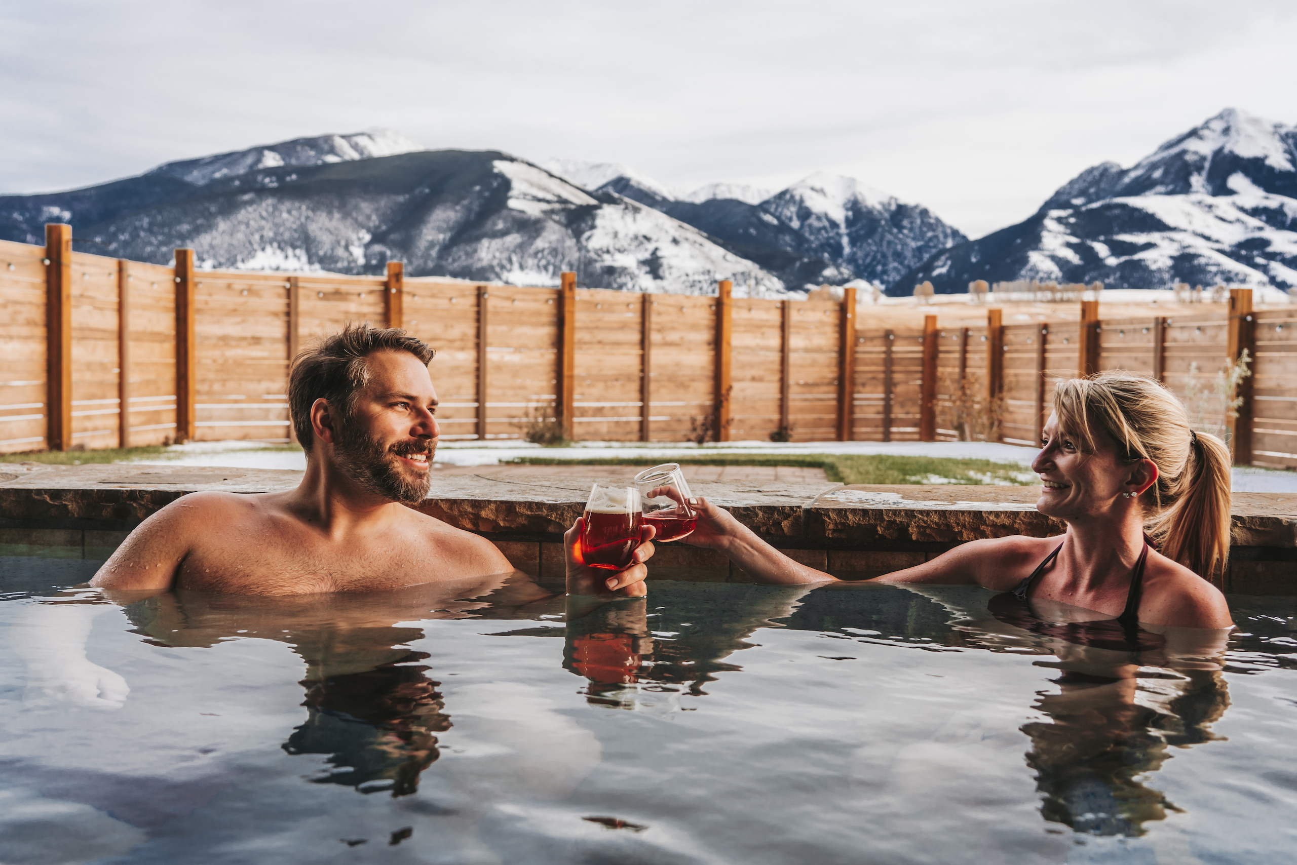man and woman toasting in hot tub