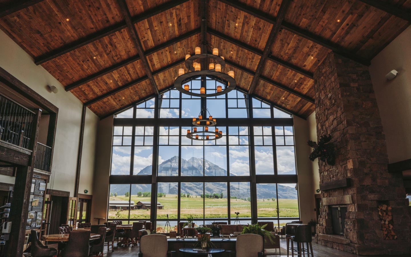 hotel lobby with expansive view of summertime mountain