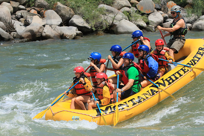Group of people river rafting.
