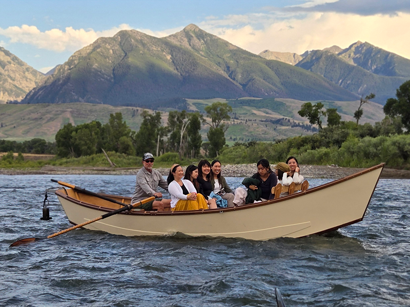 Group of people enjoying a scenic float on the Yellowstone River.
